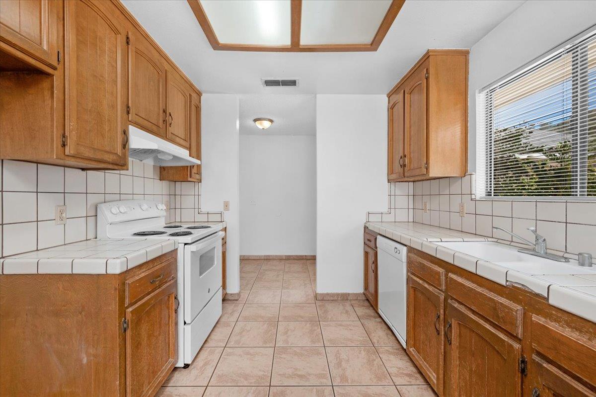 28340 Tollhouse Road Tollhouse, CA 93667 - Photo 8 of 37 a kitchen with a sink a stove top oven and cabinets