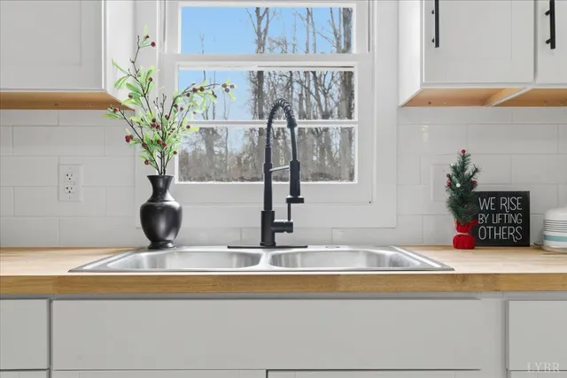 a view of kitchen with kitchen island the floor and window