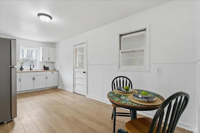a view of dining room with furniture and wooden floor