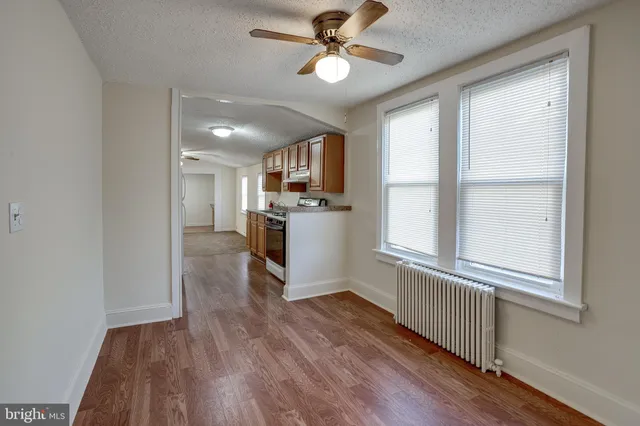 a kitchen with wooden floors and appliances