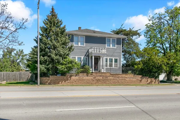 a front view of a house with a garden