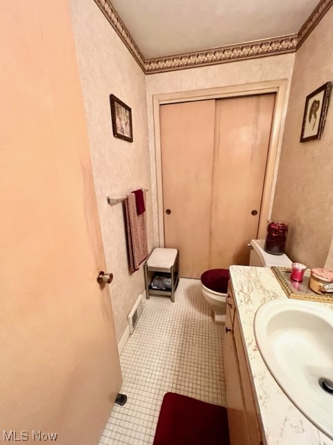 2480 Noble Road Cleveland, OH 44121 - Photo 19 of 31 Bathroom featuring toilet, vanity, and tile flooring