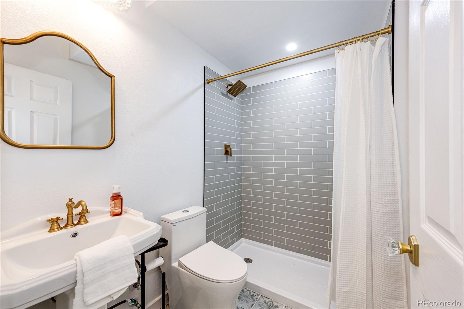 1951 Ruffino Drive Colorado Springs, CO 80921 - Photo 22 of 39 a bathroom with a sink toilet and shower