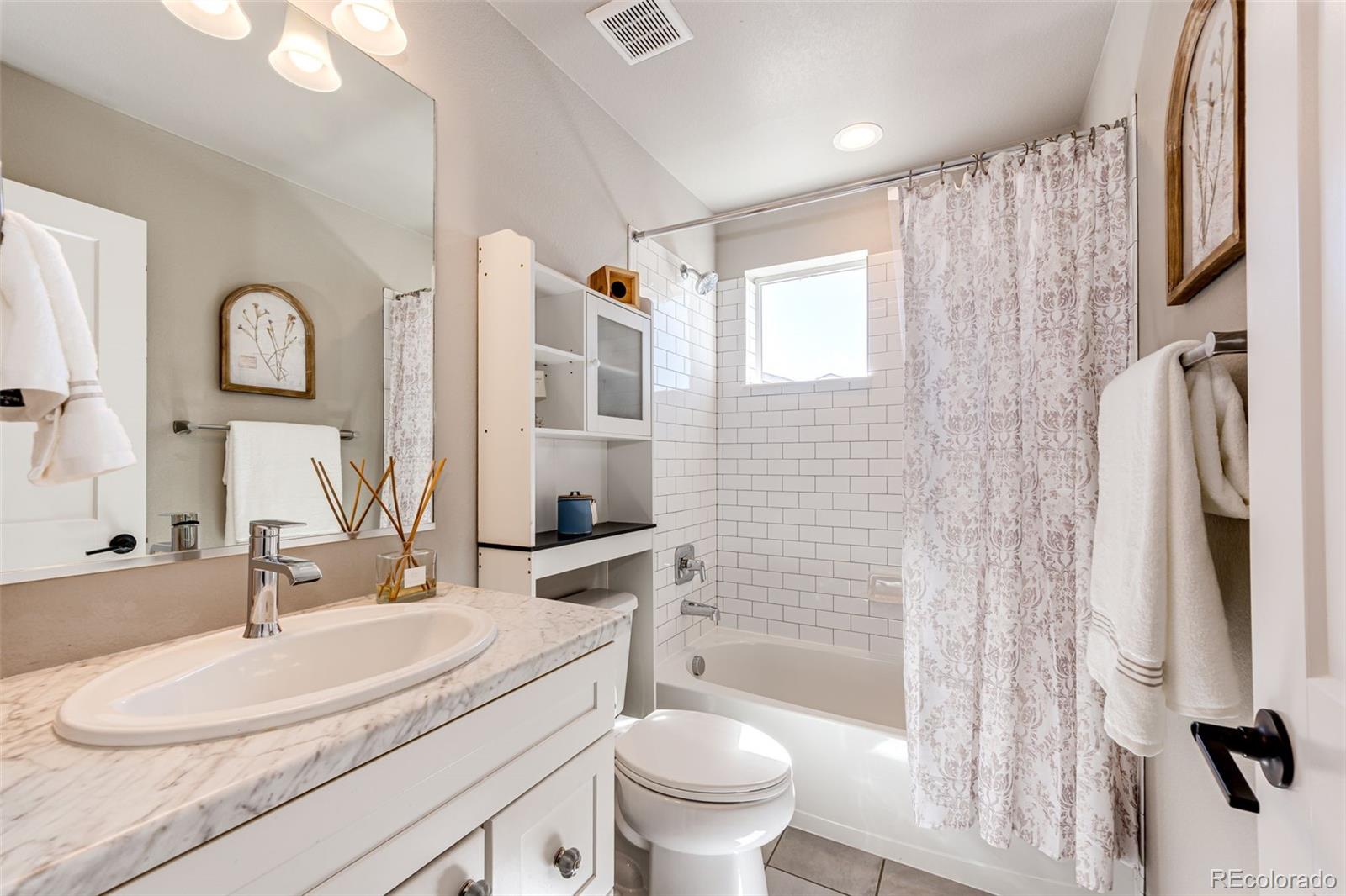 1951 Ruffino Drive Colorado Springs, CO 80921 - Photo 10 of 39 a bathroom with a granite countertop sink toilet and shower