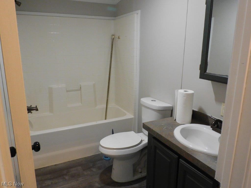 6045 Gore Road Ashtabula, OH 44004 - Photo 15 of 23 MAIN Full bathroom with hardwood flooring, bathtub / shower combination, vanity, and toilet