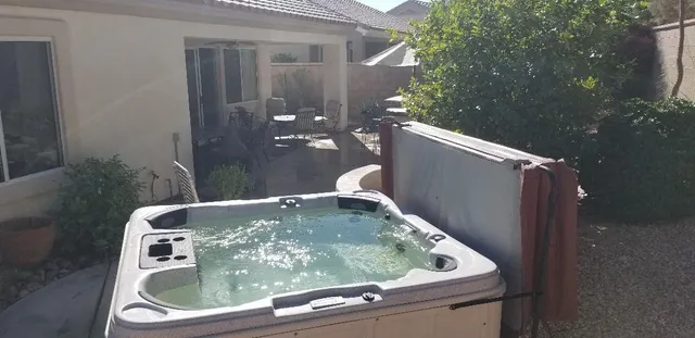 a roof deck with table and chairs under an umbrella