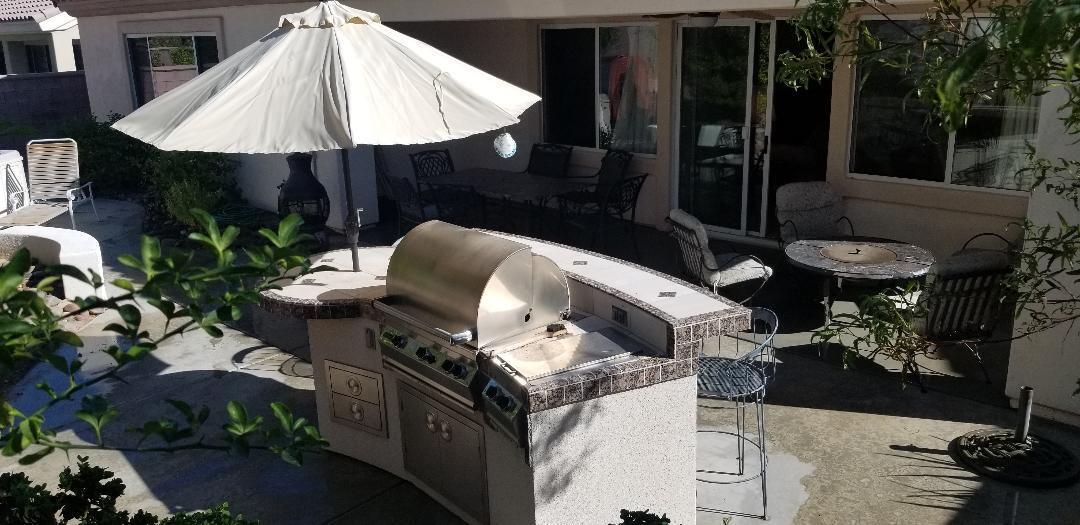 35201 Cornet Way Palm Desert, CA 92211 - Photo 16 of 35 a roof deck with table and chairs under an umbrella