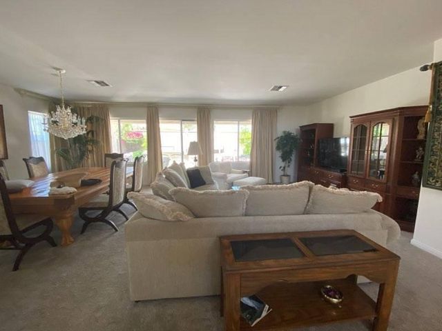 a living room with furniture and a gym machine