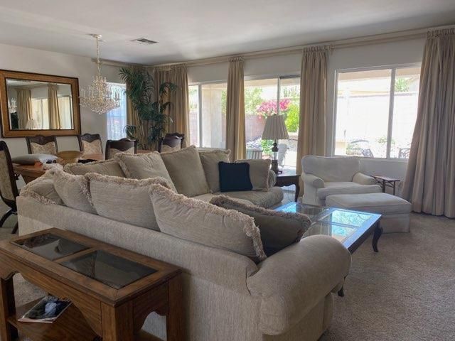 a view of a dining room with furniture and a window