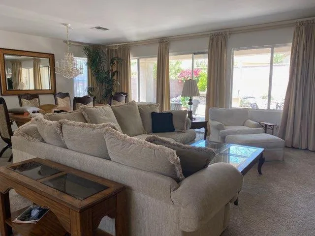 a view of a dining room with furniture and a window