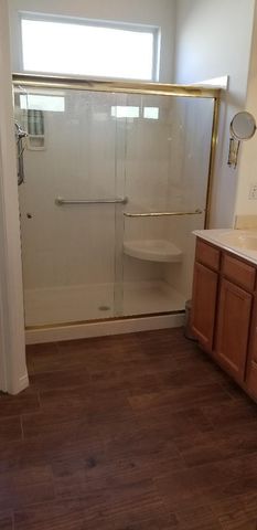 a view of a patio with table and chairs under an umbrella