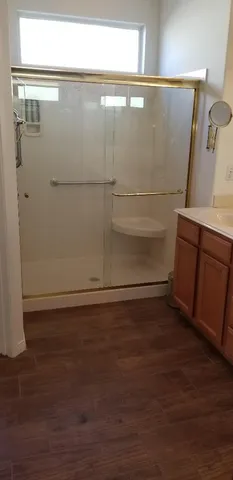 a view of a patio with table and chairs under an umbrella