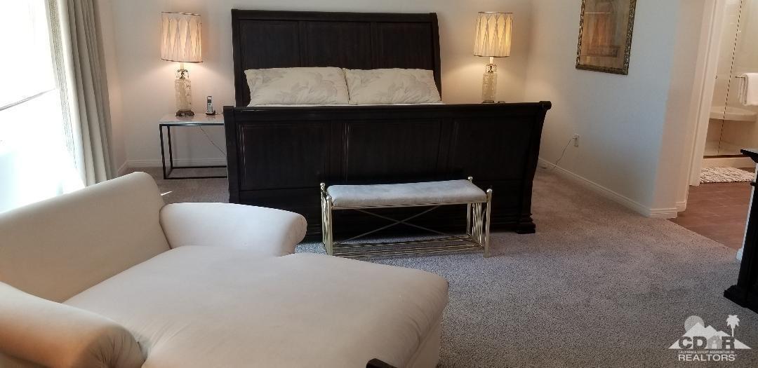 35201 Cornet Way Palm Desert, CA 92211 - Photo 3 of 35 a living room with furniture a lamp and a fireplace