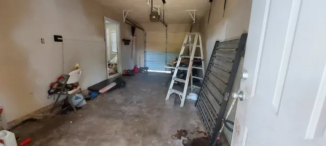 a view of a yard with a house and a large tree