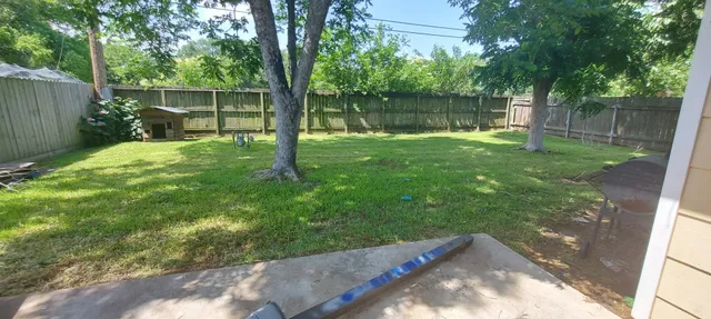 a backyard of a house with table and chairs