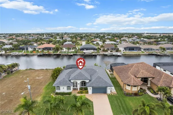an aerial view of a house with a lake view