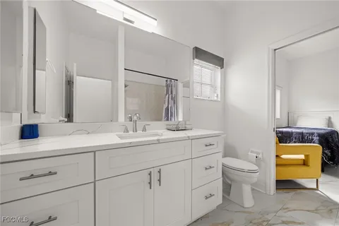 a bathroom with a toilet a sink and a mirror