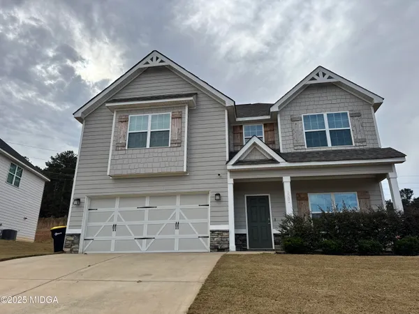 a front view of a house with garden