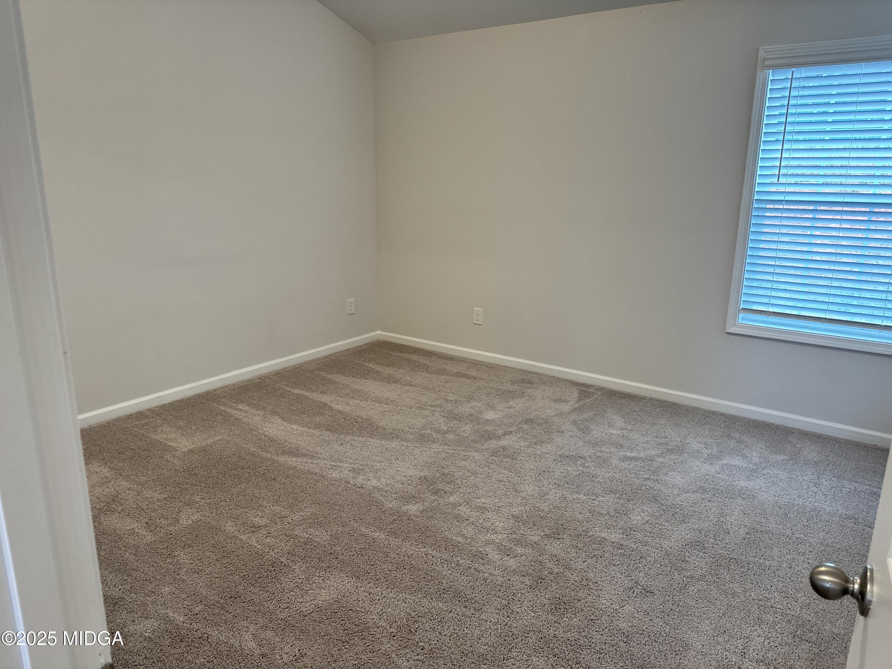 1082 Victorian Boulevard Forsyth, GA 31029 - Photo 12 of 23 an empty room with a workbench