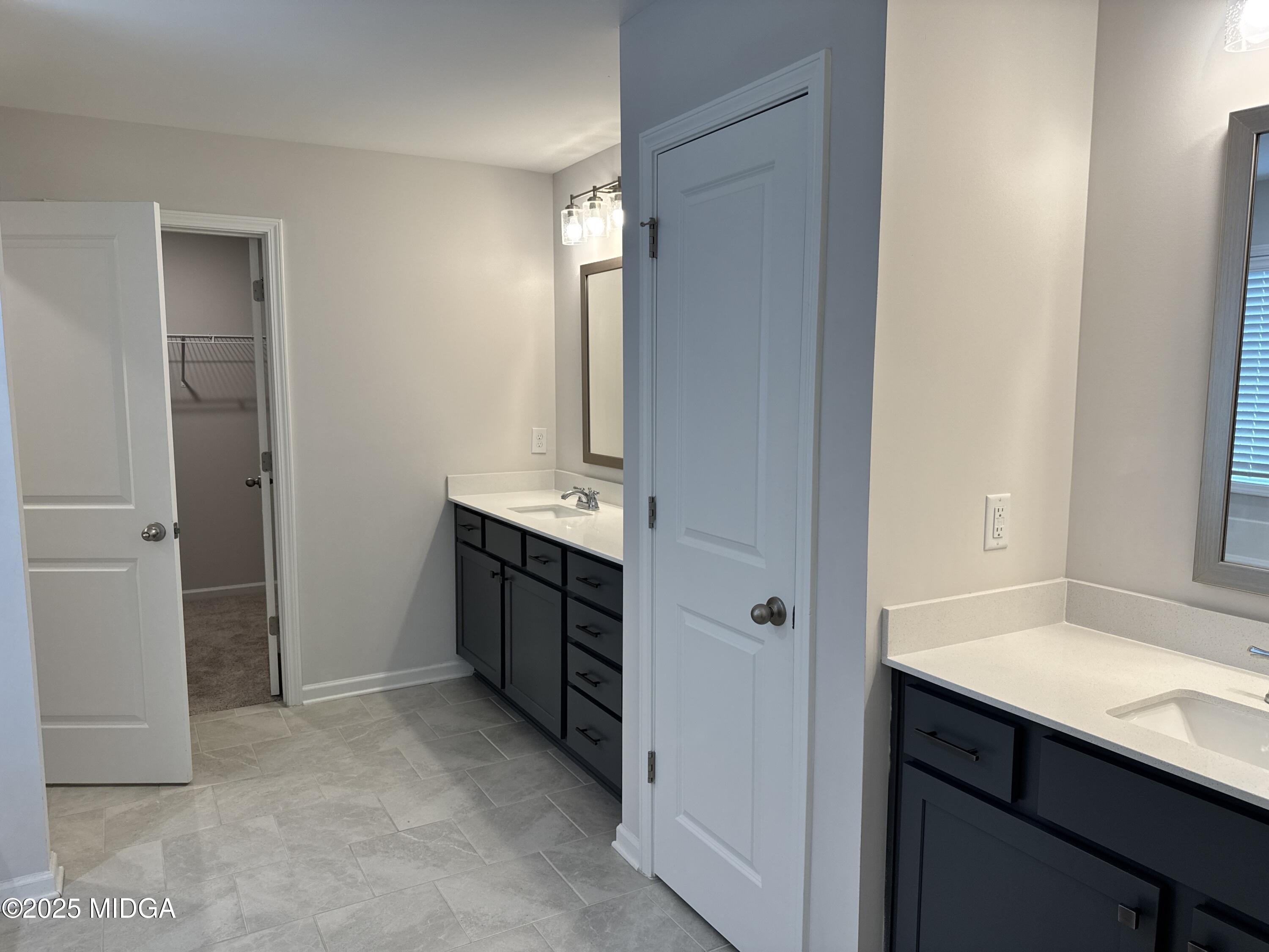 1082 Victorian Boulevard Forsyth, GA 31029 - Photo 15 of 23 a bathroom with a sink and a mirror