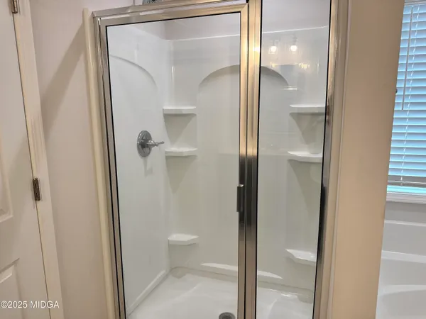 a bathroom that has a glass shower door