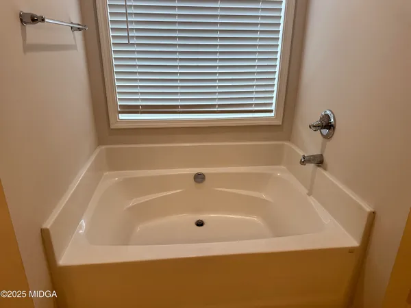 a white bath tub sitting next to a window