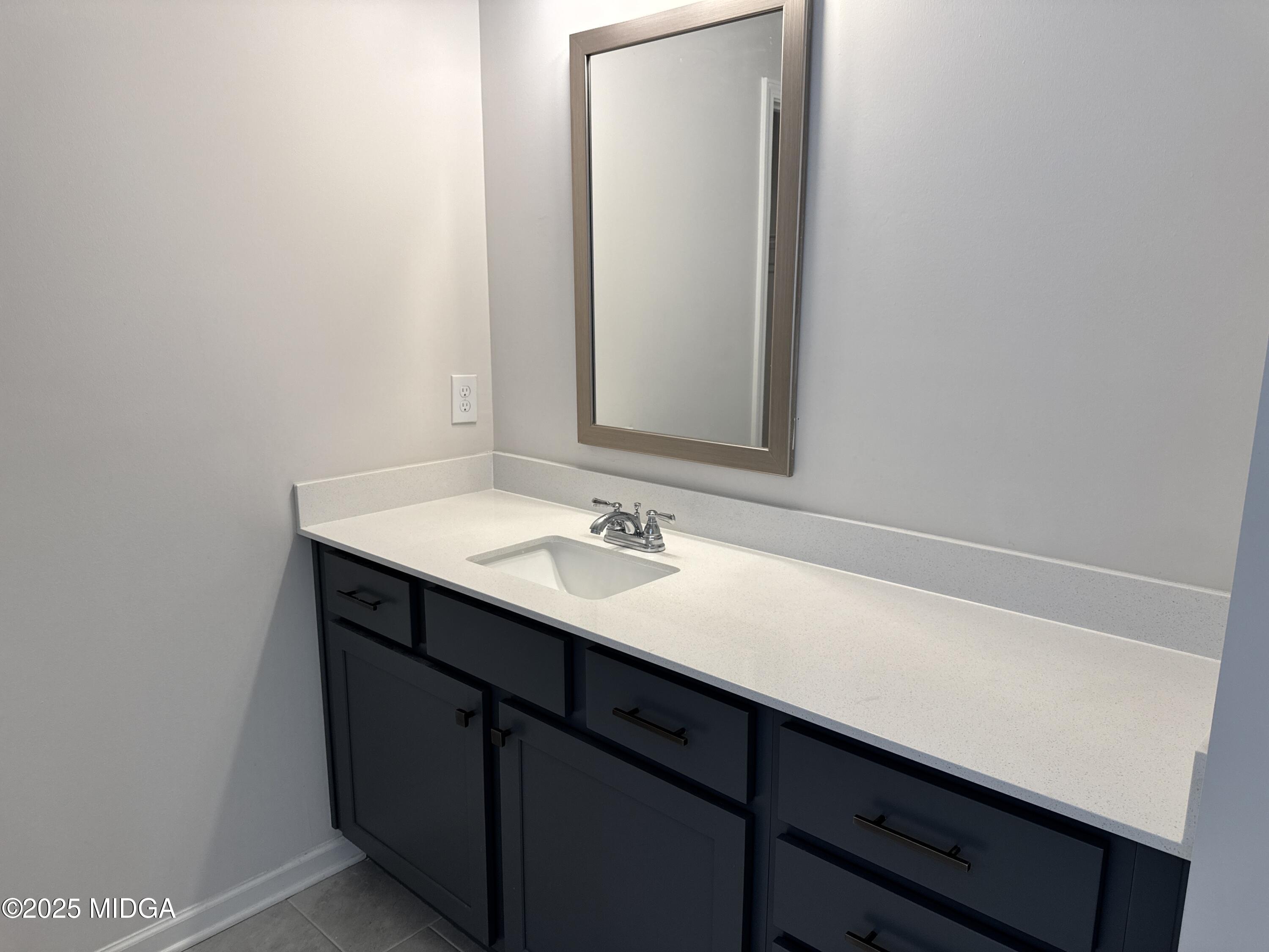 1082 Victorian Boulevard Forsyth, GA 31029 - Photo 18 of 23 a bathroom with a sink and a mirror