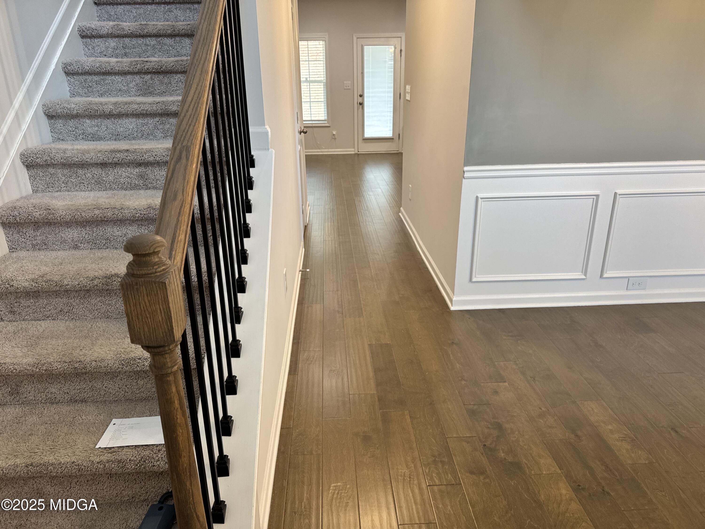 1082 Victorian Boulevard Forsyth, GA 31029 - Photo 2 of 23 an entryway with a floor to ceiling window and stairs