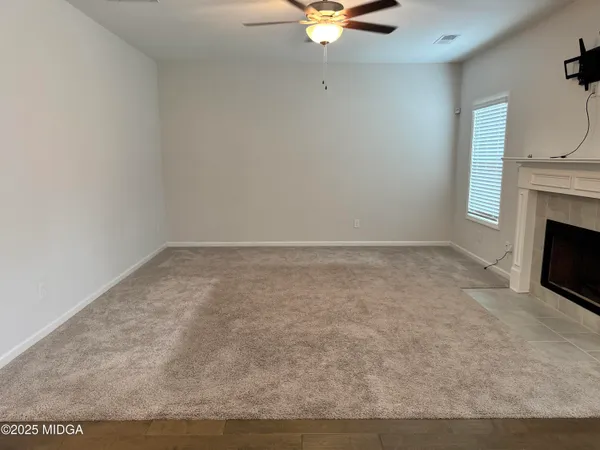 a view of an empty room with a fireplace