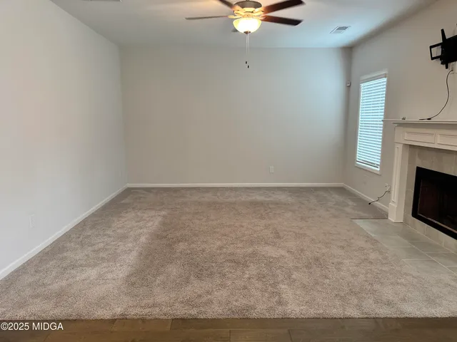 a view of an empty room with a fireplace