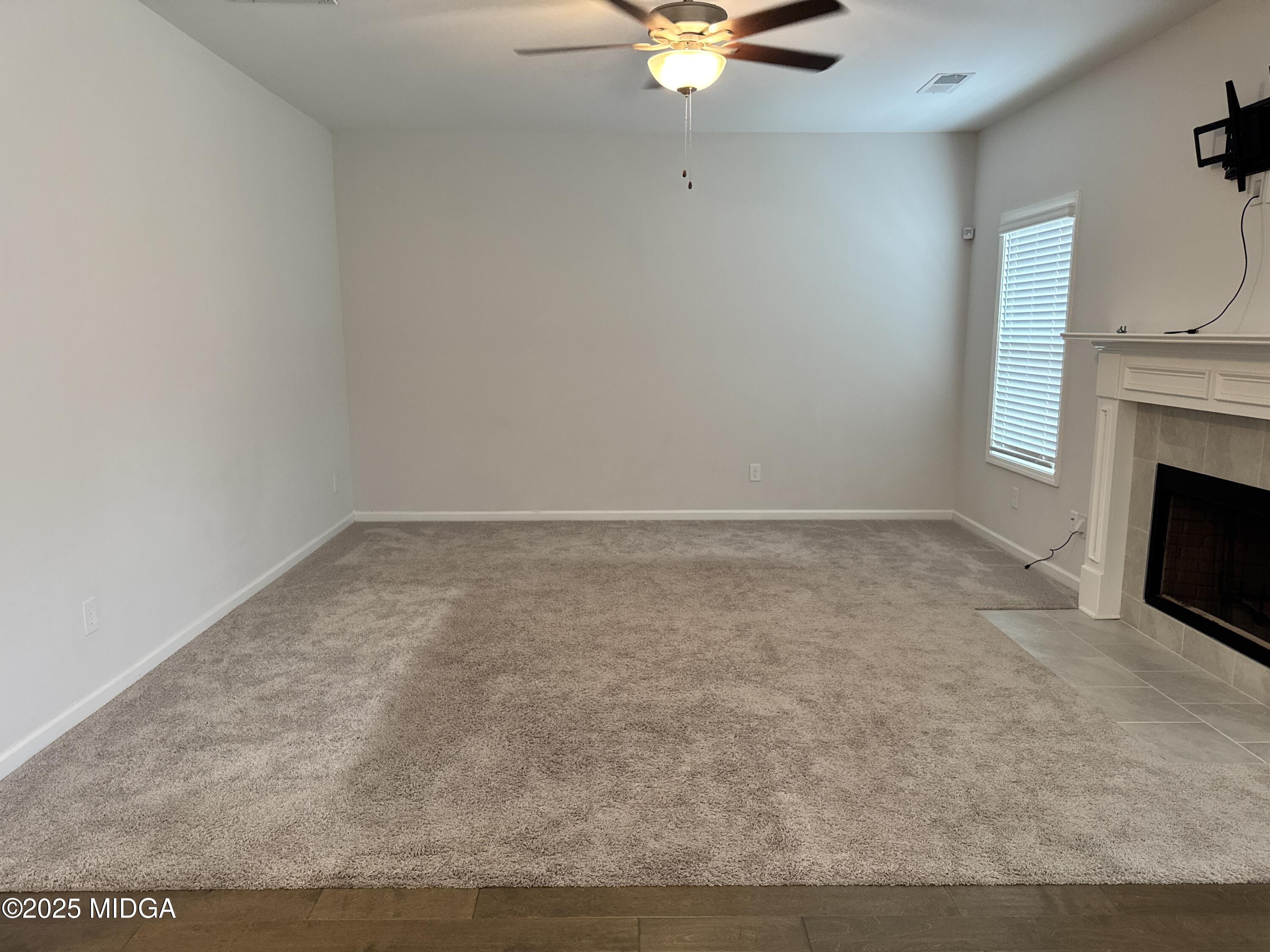 1082 Victorian Boulevard Forsyth, GA 31029 - Photo 4 of 23 a view of an empty room with a fireplace