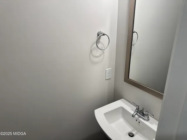 a bathroom with a sink and mirror