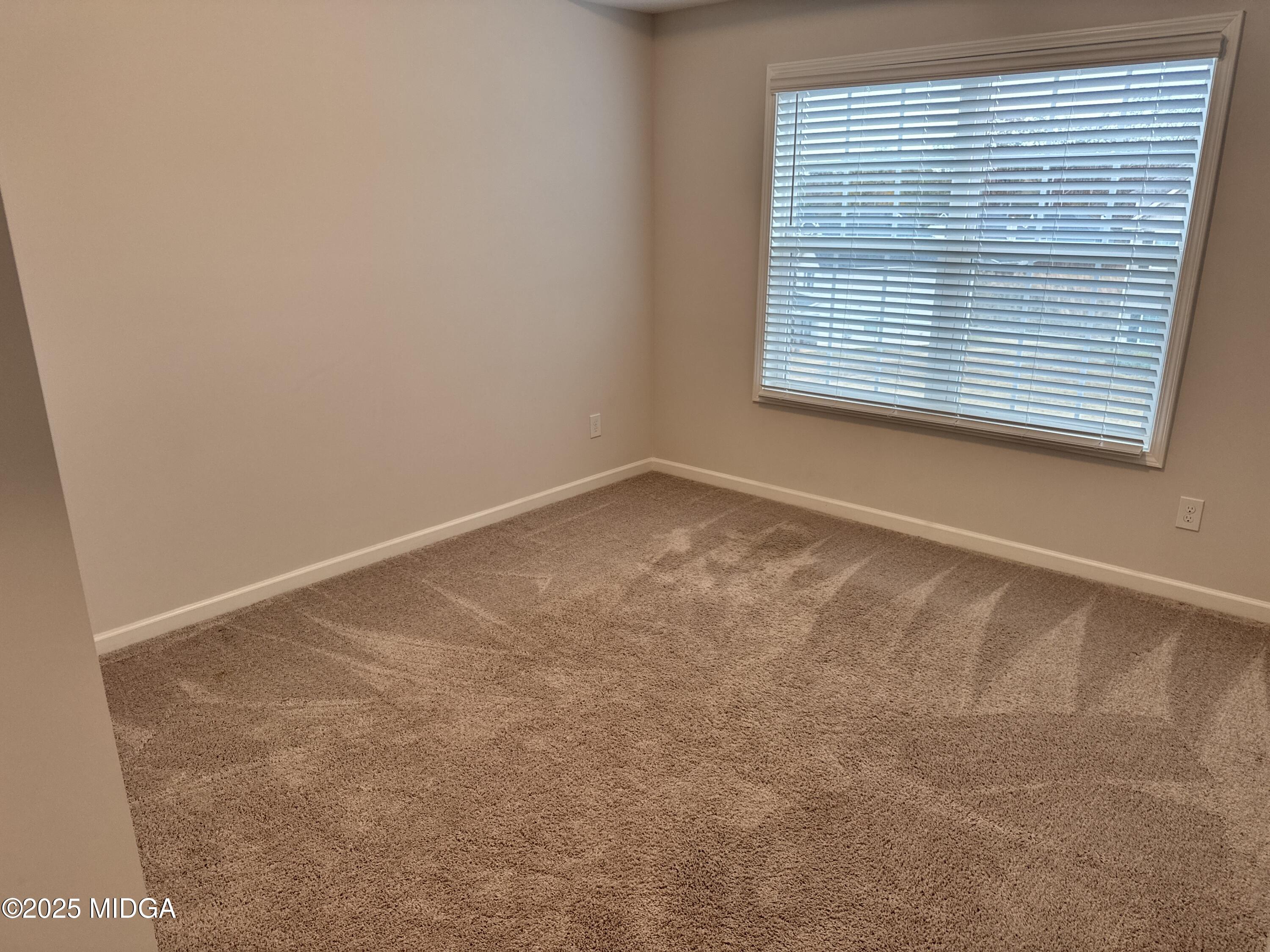 1082 Victorian Boulevard Forsyth, GA 31029 - Photo 10 of 23 an empty room with a window