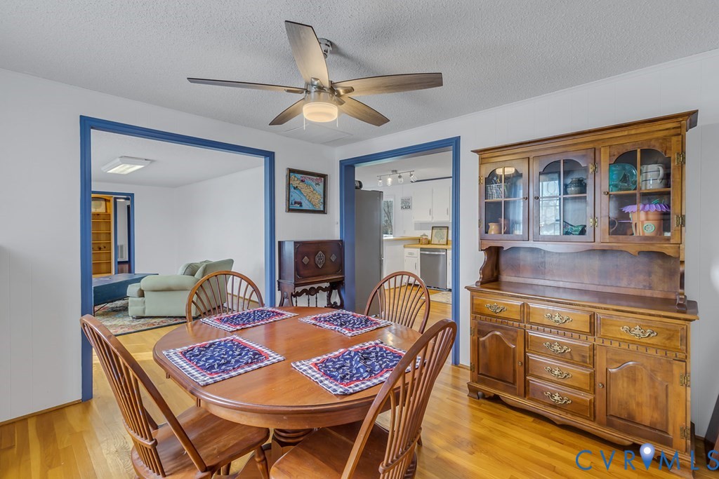 2082 Fleeton Road Reedville, VA 22539 - Photo 13 of 34 a view of a dining room with furniture a chandelier and wooden floor