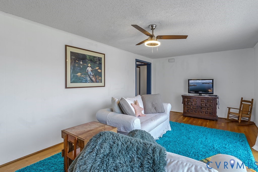 2082 Fleeton Road Reedville, VA 22539 - Photo 14 of 34 a living room with furniture and a wooden floor