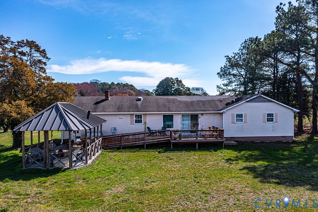 2082 Fleeton Road Reedville, VA 22539 - Photo 22 of 34 a view of a house with a big yard and large trees