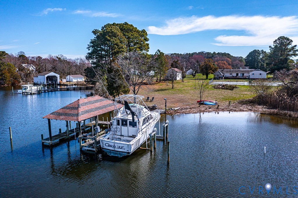 2082 Fleeton Road Reedville, VA 22539 - Photo 31 of 34 a view of a lake with a table chairs and a fire pit