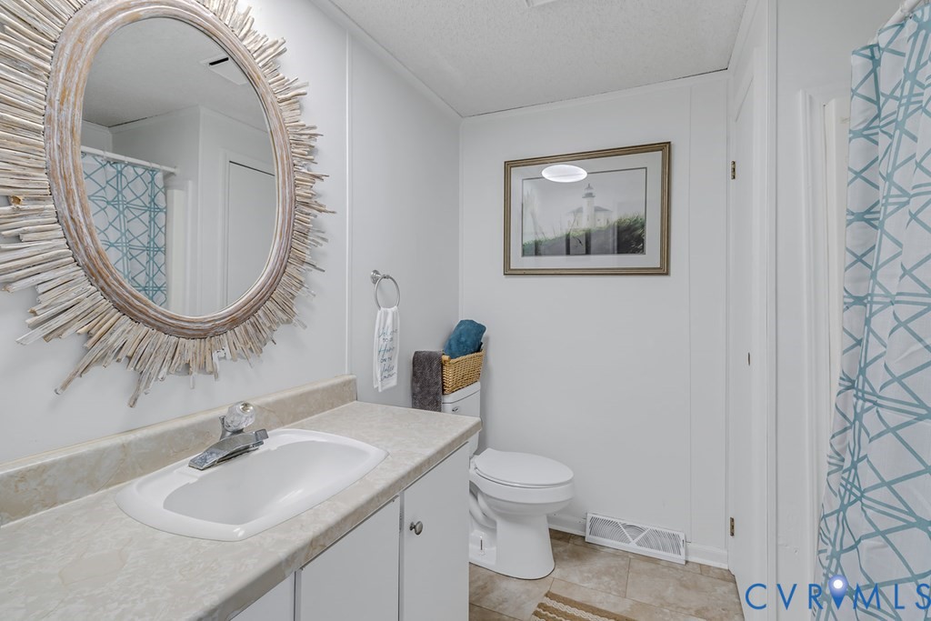 2082 Fleeton Road Reedville, VA 22539 - Photo 9 of 34 a bathroom with a toilet a sink and a mirror