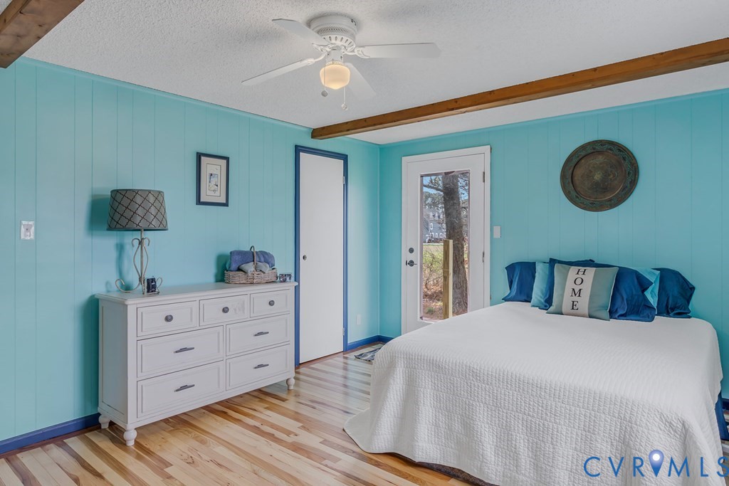 2082 Fleeton Road Reedville, VA 22539 - Photo 10 of 34 a bedroom with a large bed and a chandelier