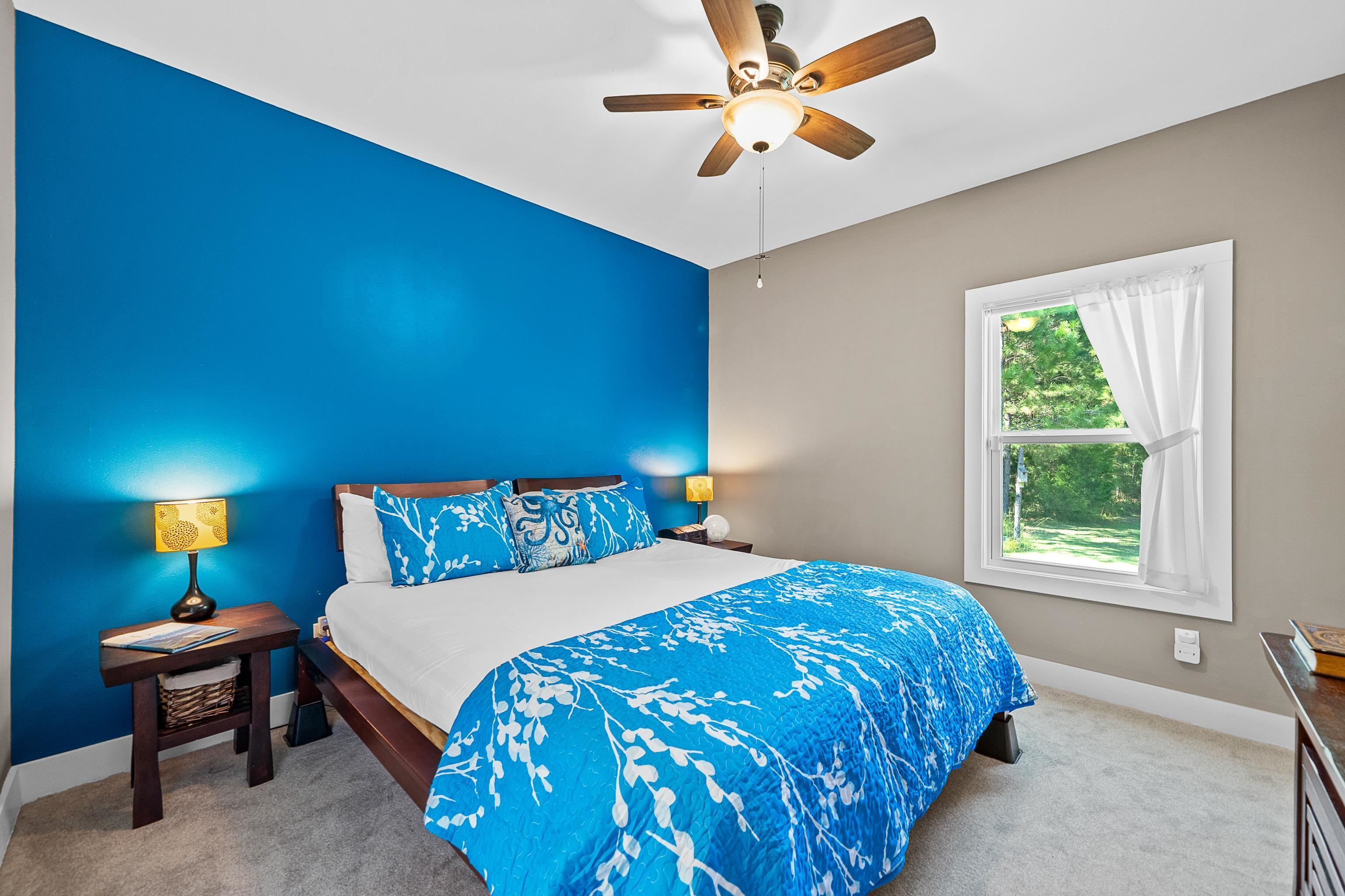 24616 Bretz Lane Elberta, AL 36530 - Photo 25 of 42 Master bedroom with new carpet (2025) and vibrant accent wall.