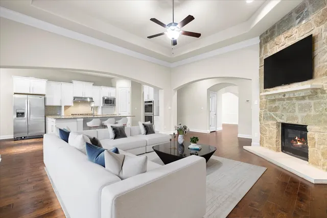 a living room with fireplace furniture and a flat screen tv
