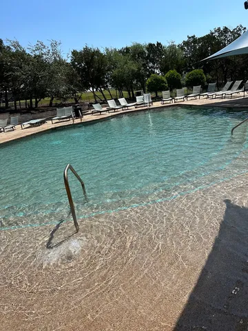 a view of a lake with boats and trees in the back