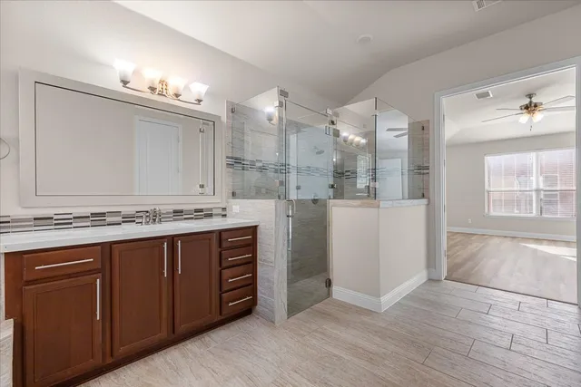 a bathroom with a sink a vanity and a large mirror