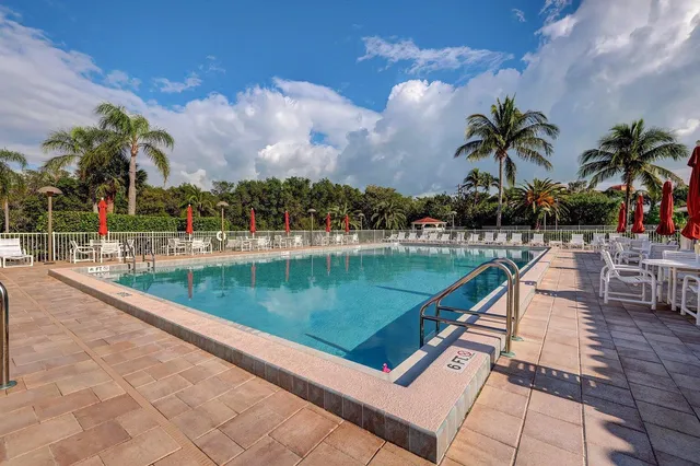 a view of swimming pool with a table and chairs