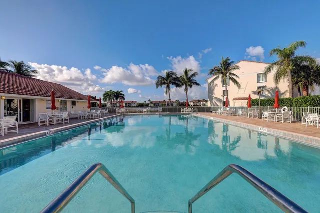 a view of swimming pool with outdoor seating and city view