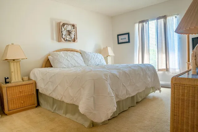 a bedroom with a bed and a lamp