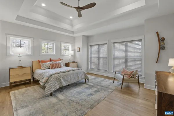 a spacious bedroom with a bed and large windows