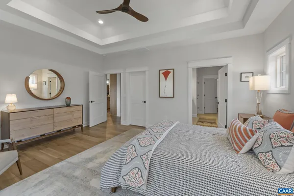 a bedroom with a bed a mirror and a table