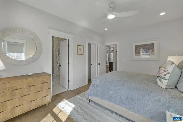 a spacious bedroom with a bed and a mirror