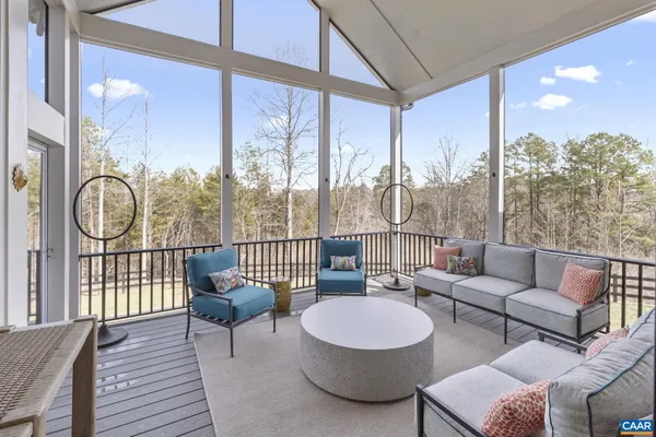 a living room with furniture and a floor to ceiling window